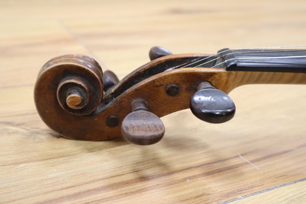 A cased violin with two bows. Violin bears the label Carl Willhelm Claesel, circa late 18th century/early 19th century, 35.5cm back in